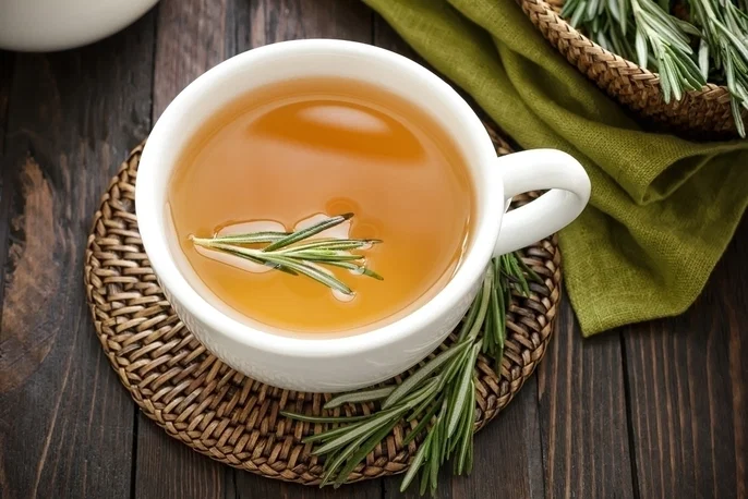 Cup of rosemary tea with fresh rosemary sprigs